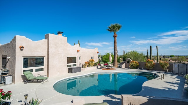 view of swimming pool featuring a fenced in pool, fence, and a patio area