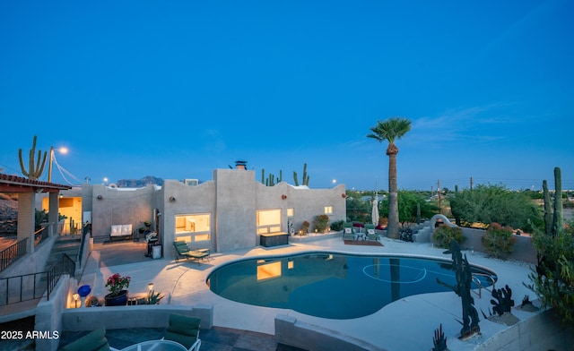 outdoor pool featuring fence and a patio area