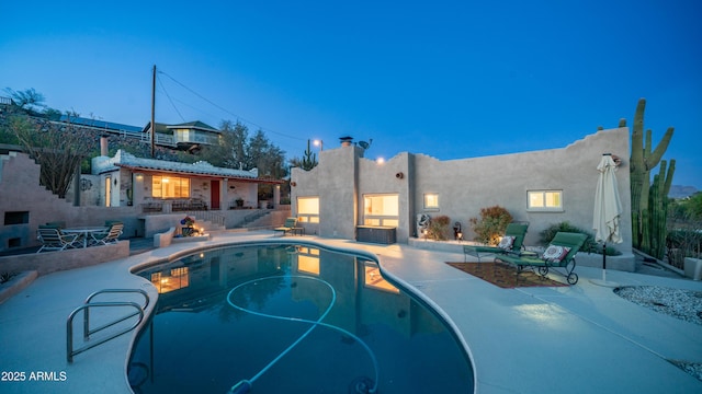 outdoor pool with a patio area