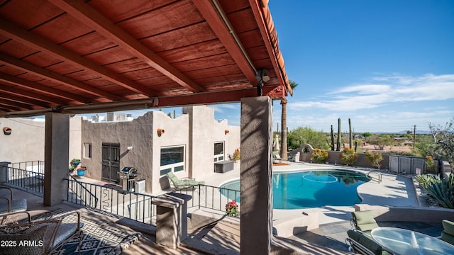 view of pool with grilling area, a fenced in pool, a fenced backyard, and a patio area