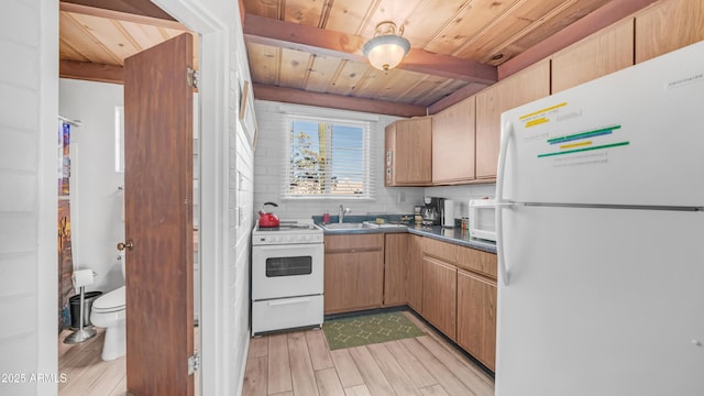 kitchen with wood ceiling, beam ceiling, a sink, white appliances, and light wood-style flooring