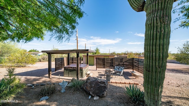 view of patio with an outdoor fire pit and fence