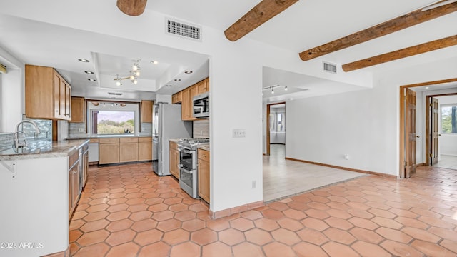 kitchen featuring appliances with stainless steel finishes, tasteful backsplash, baseboards, and visible vents