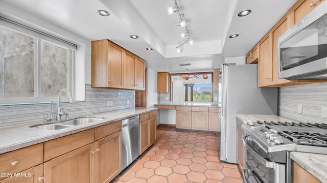 kitchen featuring light tile patterned flooring, appliances with stainless steel finishes, a sink, recessed lighting, and tasteful backsplash