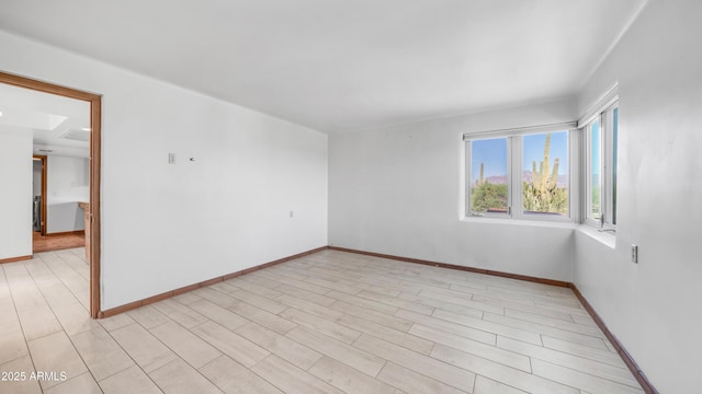 spare room featuring baseboards