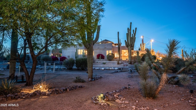 view of front of property with fence and stucco siding