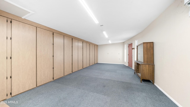 below grade area featuring baseboards and carpet