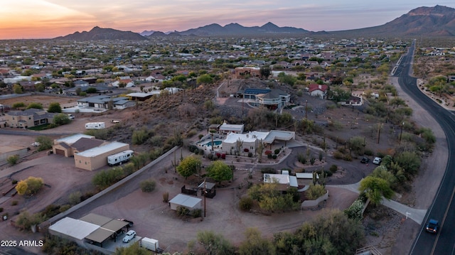 aerial view at dusk featuring a residential view and a mountain view