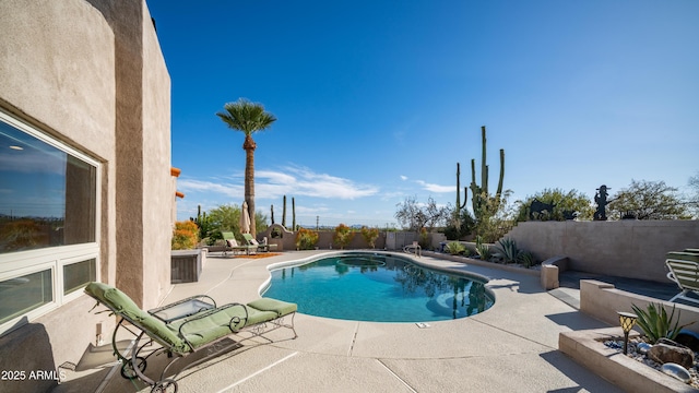 view of pool with a fenced in pool, a fenced backyard, and a patio area