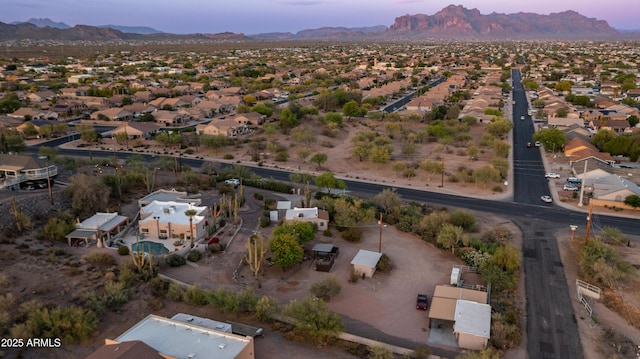 aerial view at dusk featuring a mountain view