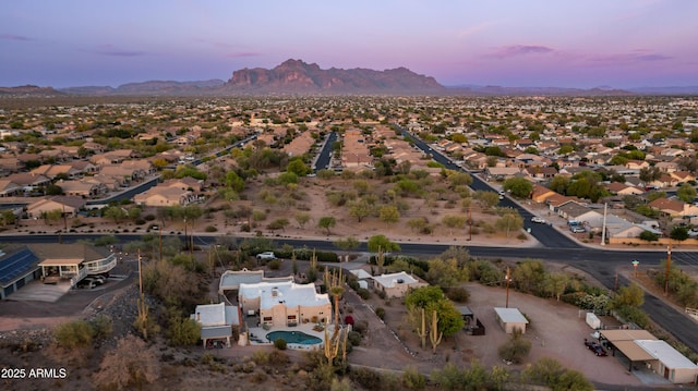 aerial view at dusk featuring a residential view and a mountain view