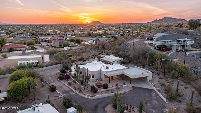 aerial view at dusk with a mountain view and a residential view