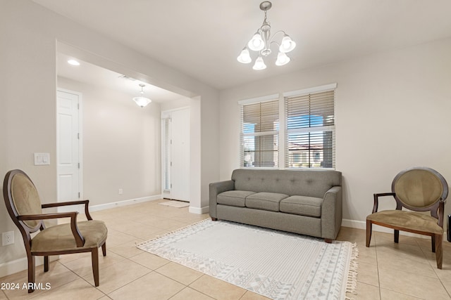 living room with a notable chandelier and light tile patterned floors