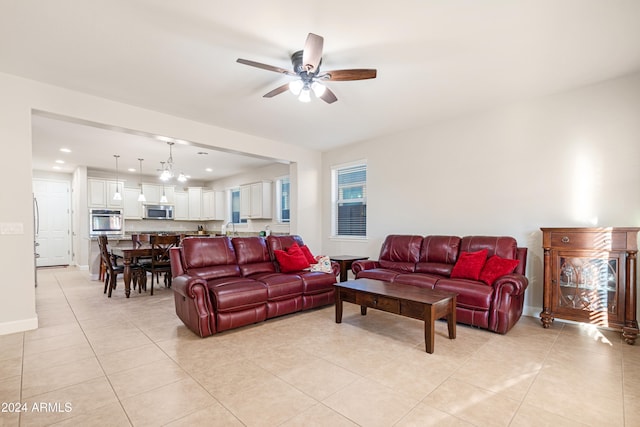 living room featuring light tile patterned floors and ceiling fan