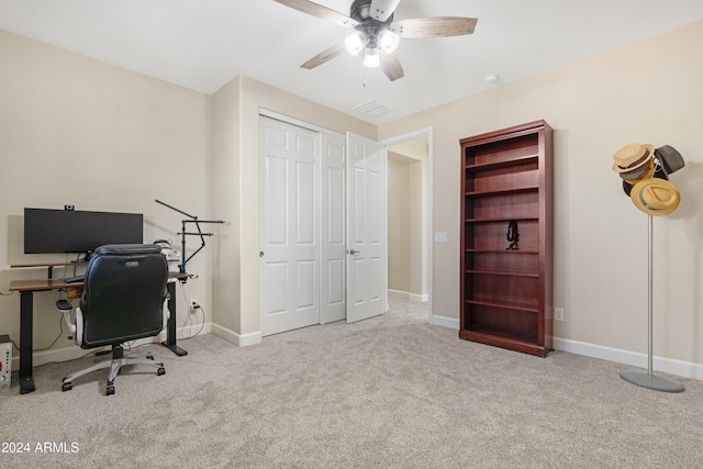 office space featuring light carpet and ceiling fan