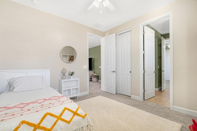 carpeted bedroom featuring a closet and ceiling fan