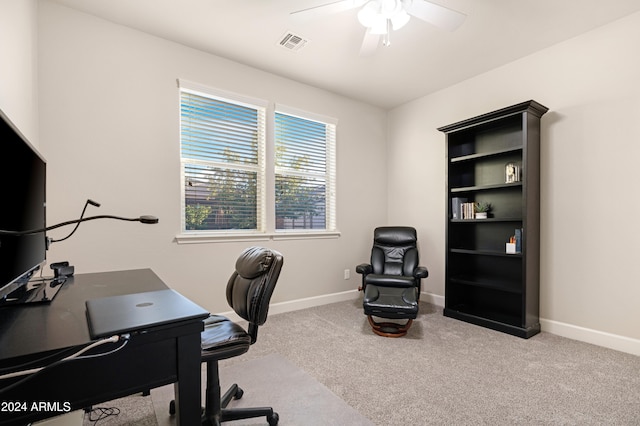 carpeted home office featuring ceiling fan