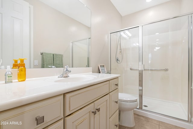 bathroom featuring vanity, tile patterned floors, toilet, and an enclosed shower