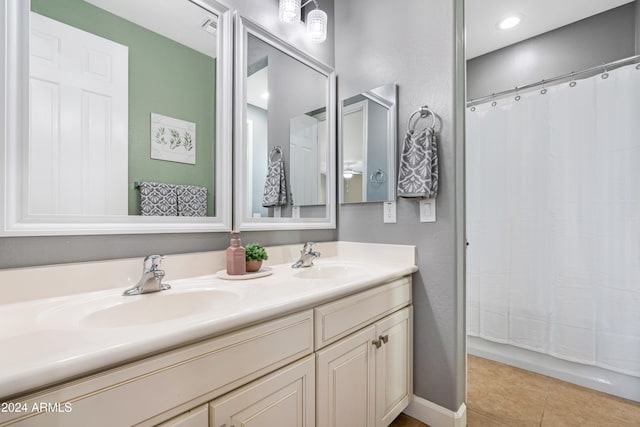 bathroom with vanity, curtained shower, and tile patterned floors