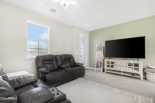 living room featuring carpet flooring and ceiling fan