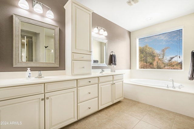 bathroom with vanity, a tub to relax in, and tile patterned floors