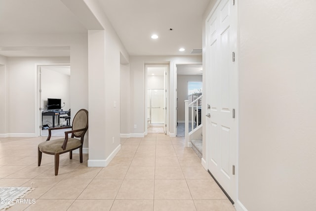 hall with light tile patterned floors