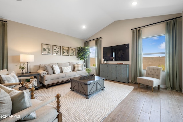 living room with vaulted ceiling and hardwood / wood-style floors