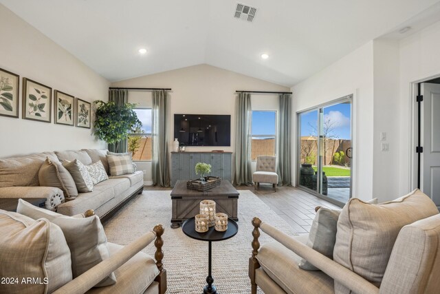 living room with vaulted ceiling and a wealth of natural light