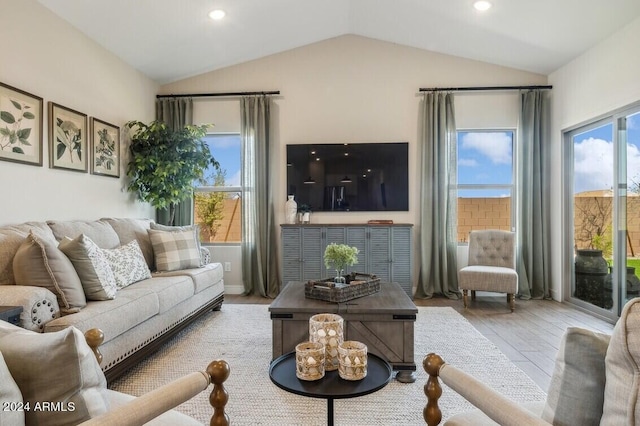 living room with light wood-type flooring and lofted ceiling