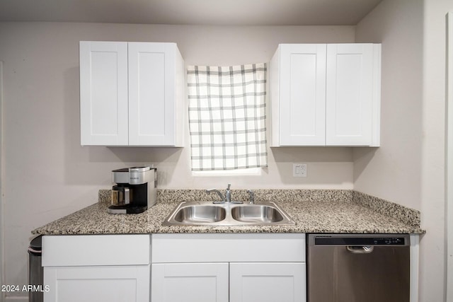 kitchen featuring white cabinetry, a sink, and stainless steel dishwasher