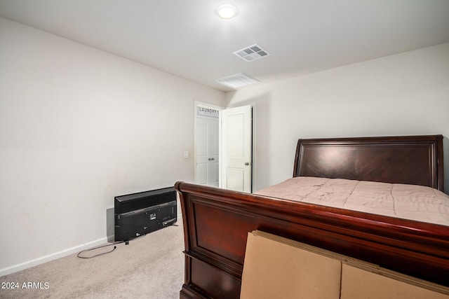 carpeted bedroom with visible vents and baseboards