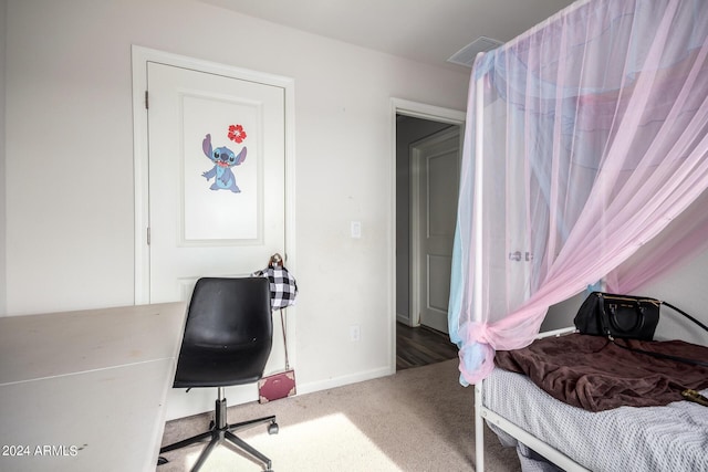 carpeted bedroom featuring visible vents and baseboards