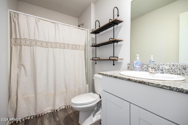 bathroom featuring vanity, shower / tub combo, wood finished floors, and toilet