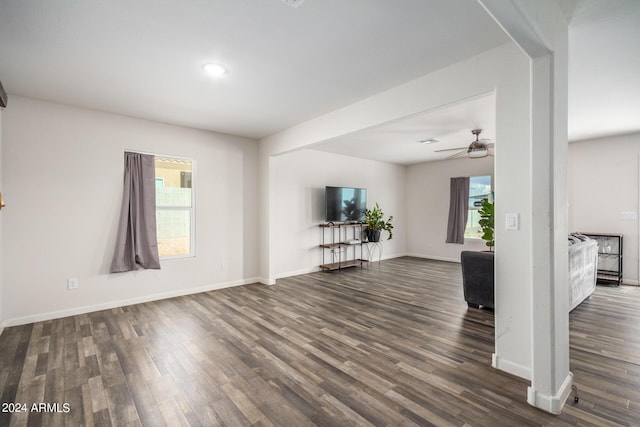 interior space with dark wood finished floors, baseboards, and ceiling fan