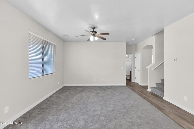 spare room with dark hardwood / wood-style floors and ceiling fan