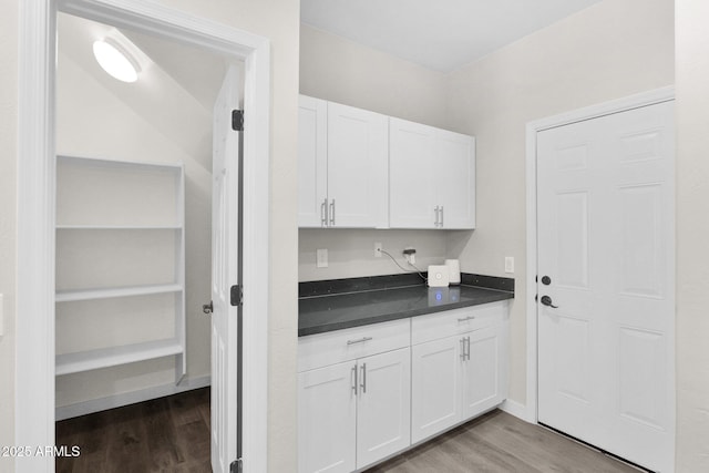 interior space with white cabinetry and light hardwood / wood-style floors