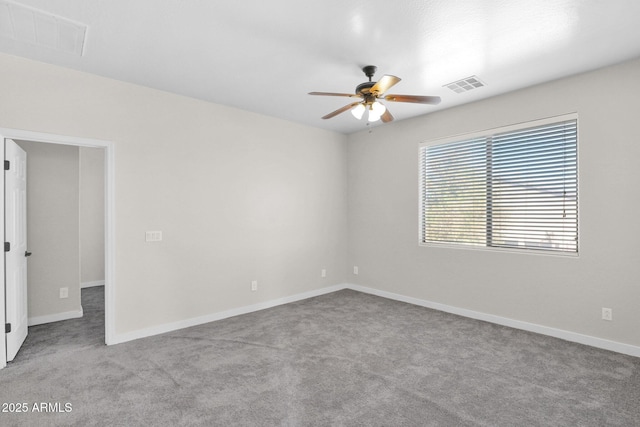 spare room with ceiling fan and light colored carpet