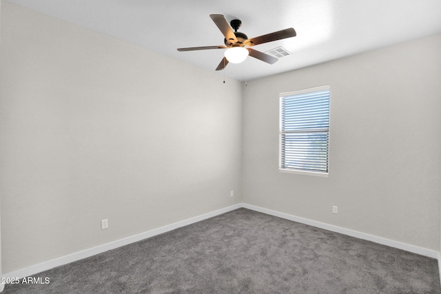 carpeted spare room featuring ceiling fan