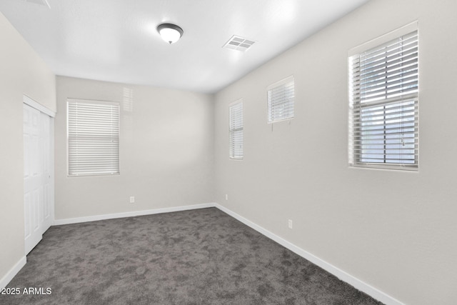 empty room with dark carpet