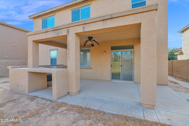 property entrance with ceiling fan and a patio