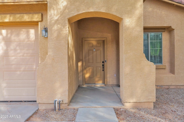 doorway to property with a garage