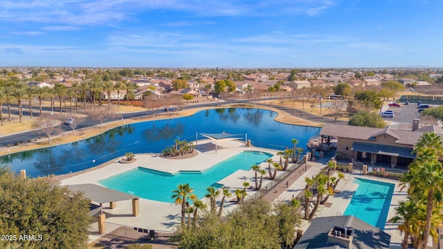 view of pool with a water view and a patio area