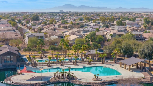 view of swimming pool featuring a gazebo, a mountain view, a water slide, and a patio area