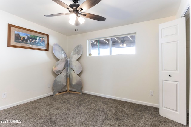 carpeted empty room featuring ceiling fan