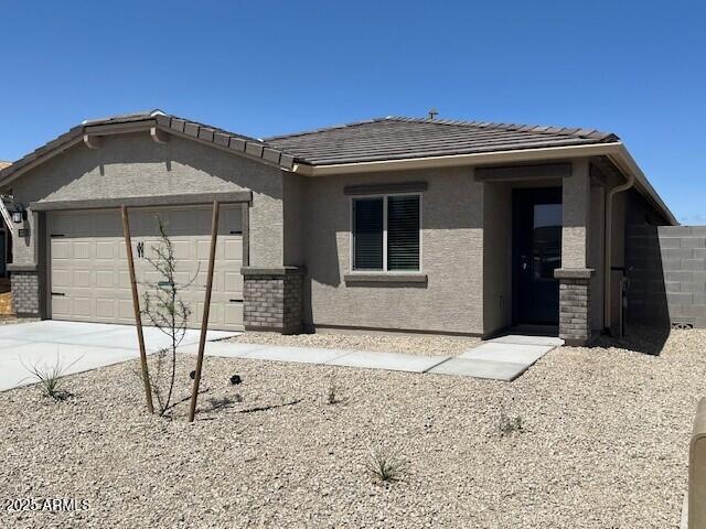 1050 W W Virginia Ave, Florence, AZ 85132 - view of front of home with a garage, driveway, and stucco siding