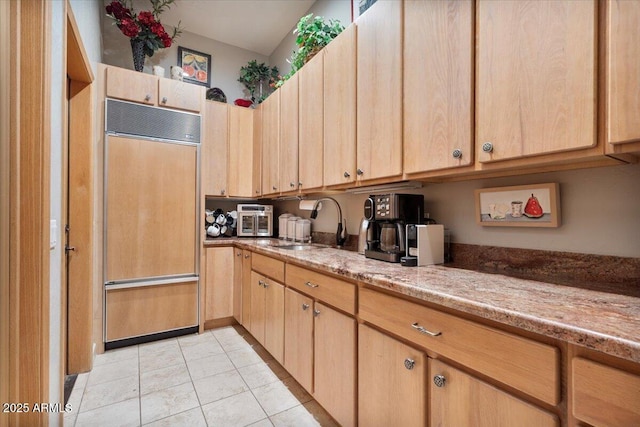 8514 E Country Club Trl, Scottsdale, AZ 85255 - kitchen featuring paneled built in fridge, a sink, light brown cabinetry, light tile patterned floors, and light stone countertops