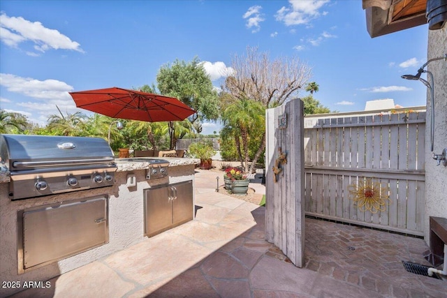 8514 E Country Club Trl, Scottsdale, AZ 85255 - view of patio with a grill, exterior kitchen, and fence