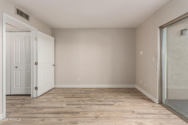 unfurnished bedroom with light wood-type flooring