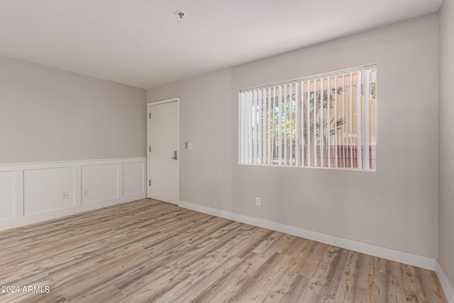 unfurnished room with light hardwood / wood-style floors