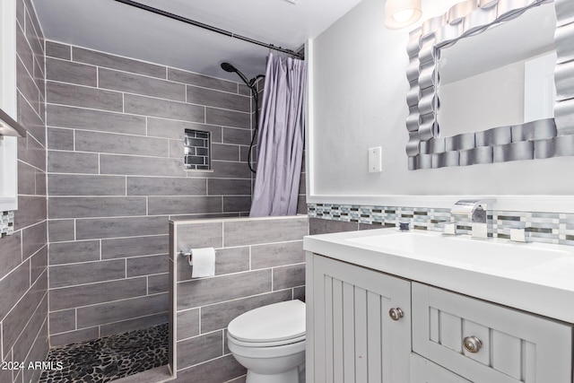 bathroom featuring a shower with curtain, tile walls, vanity, and toilet